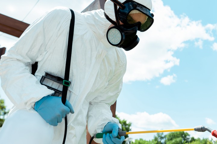 Workman In Hazmat Suit And Facemask Disinfecting W 2026 01 06 00 25 48 Utc